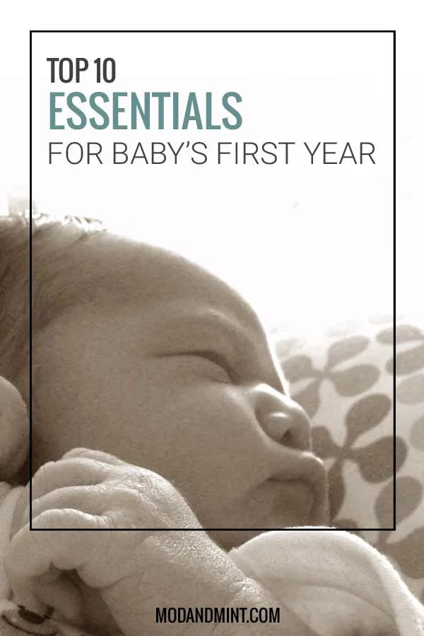 Black and white phot of baby sleeping. Text on image: Top 10 Essentials for Baby's First Year. modandmint.com