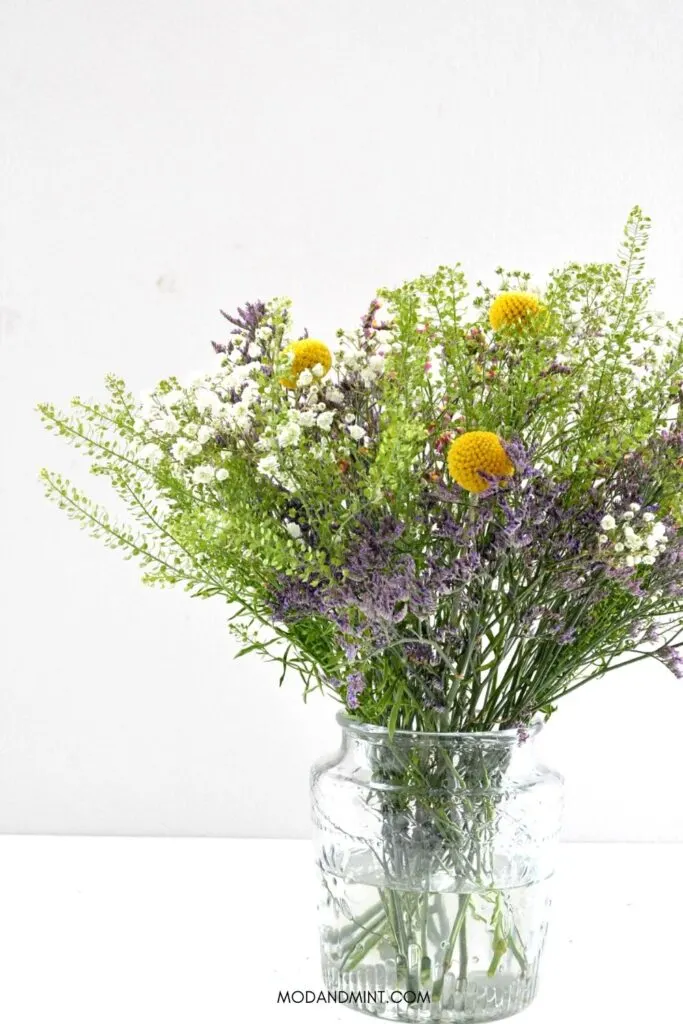 Spring bouquet of purple, yellow and green wild flowers.